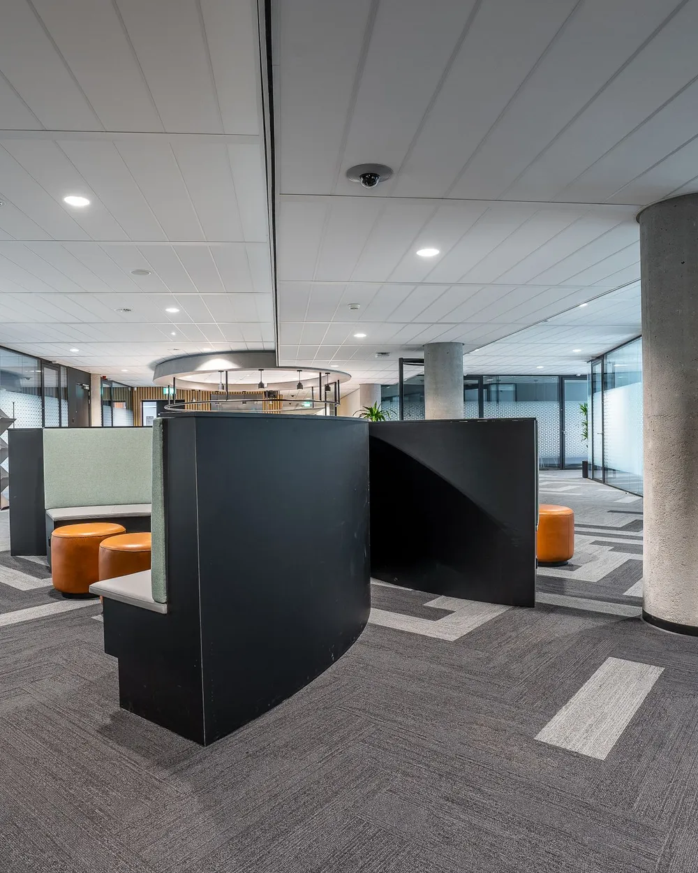 An open-plan commercial office interior with painted walls, ceiling and a structural column.